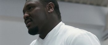 Movie still from “Happy-Go-Lucky” (2008), directed by Mike Leigh – A person wearing a white shirt; Close Up shot, Low angle