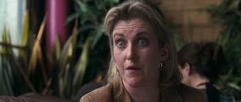 Movie still from “Happy-Go-Lucky” (2008), directed by Mike Leigh – A person with a surprised look on their face; Close Up shot, Over the shoulder angle