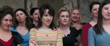 Movie still from “Happy-Go-Lucky” (2008), directed by Mike Leigh – A group of women standing next to each other; Close Up shot, Over the shoulder angle