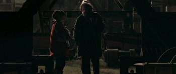 Movie still from “Happy-Go-Lucky” (2008), directed by Mike Leigh – A man and a woman standing next to each other in the dark; Medium shot, Over the shoulder angle