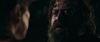 Movie still from “Happy-Go-Lucky” (2008), directed by Mike Leigh – A man with a long beard is looking at the camera; Close Up shot, Over the shoulder angle