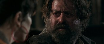 Movie still from “Happy-Go-Lucky” (2008), directed by Mike Leigh – A person with a beard; Close Up shot, Over the shoulder angle