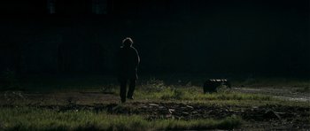 Movie still from “Happy-Go-Lucky” (2008), directed by Mike Leigh – A person walking in a field at night; Extreme Wide shot, Over the shoulder angle