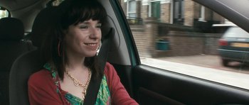 Movie still from “Happy-Go-Lucky” (2008), directed by Mike Leigh – A woman sitting in the passenger seat of a car; Close Up shot, Over the shoulder angle