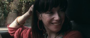 Movie still from “Happy-Go-Lucky” (2008), directed by Mike Leigh – A person wearing a red shirt; Close Up shot, Over the shoulder angle