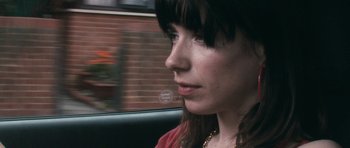 Movie still from “Happy-Go-Lucky” (2008), directed by Mike Leigh – A woman sitting in the back seat of a car looking out the window; Close Up shot, Over the shoulder angle