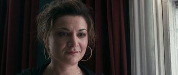 Movie still from “Happy-Go-Lucky” (2008), directed by Mike Leigh – A person wearing a black shirt; Close Up shot, Over the shoulder angle