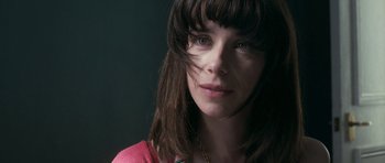 Movie still from “Happy-Go-Lucky” (2008), directed by Mike Leigh – A person wearing a pink shirt; Close Up shot, Over the shoulder angle