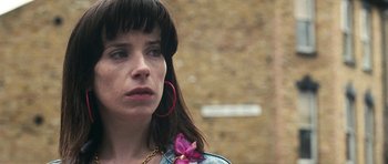 Movie still from “Happy-Go-Lucky” (2008), directed by Mike Leigh – A person with a flower in her hair; Close Up shot, Over the shoulder angle