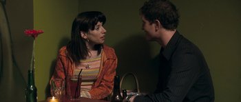 Movie still from “Happy-Go-Lucky” (2008), directed by Mike Leigh – A man and a woman are sitting at a table talking; Close Up shot, Over the shoulder angle
