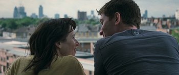 Movie still from “Happy-Go-Lucky” (2008), directed by Mike Leigh – A man and a woman sitting next to each other; Close Up shot, Over the shoulder angle