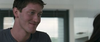 Movie still from “Happy-Go-Lucky” (2008), directed by Mike Leigh – A person smiling for the camera; Close Up shot, Over the shoulder angle