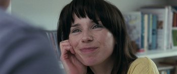 Movie still from “Happy-Go-Lucky” (2008), directed by Mike Leigh – A person smiling and holding a cell phone; Close Up shot, Low angle