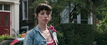 Movie still from “Happy-Go-Lucky” (2008), directed by Mike Leigh – A woman with a flower in her hair; Close Up shot, Over the shoulder angle