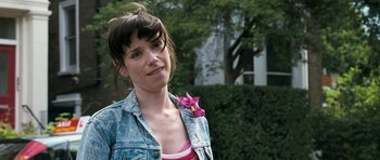 Movie still from “Happy-Go-Lucky” (2008), directed by Mike Leigh – A woman with a flower in her mouth; Close Up shot, Low angle