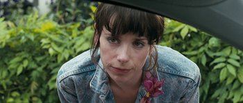 Movie still from “Happy-Go-Lucky” (2008), directed by Mike Leigh – A person wearing a jean jacket; Close Up shot, Over the shoulder angle