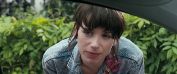 Movie still from “Happy-Go-Lucky” (2008), directed by Mike Leigh – A person with a flower in their hair; Close Up shot, Over the shoulder angle