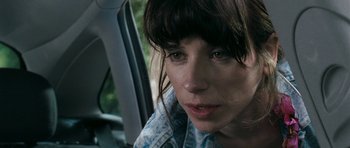 Movie still from “Happy-Go-Lucky” (2008), directed by Mike Leigh – A person sitting in a car; Close Up shot, Over the shoulder angle