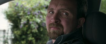 Movie still from “Happy-Go-Lucky” (2008), directed by Mike Leigh – A person with a beard looking at the camera; Close Up shot, Low angle