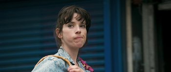 Movie still from “Happy-Go-Lucky” (2008), directed by Mike Leigh – A person holding a banana; Close Up shot, Over the shoulder angle