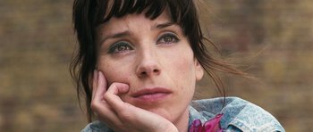 Movie still from “Happy-Go-Lucky” (2008), directed by Mike Leigh – A person with her hand under her chin; Close Up shot, Low angle