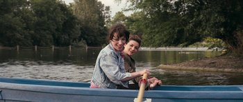 Movie still from “Happy-Go-Lucky” (2008), directed by Mike Leigh – Two women are in a boat on a river; Medium shot, High angle