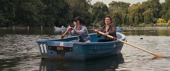 Movie still from “Happy-Go-Lucky” (2008), directed by Mike Leigh – A couple of women are rowing a boat in the water; Wide shot, High angle