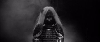 Movie still from “Harakiri” (1962), directed by Masaki Kobayashi – A black and white photo of a person wearing a samurai armor; Close Up shot, Low angle