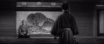 Movie still from “Harakiri” (1962), directed by Masaki Kobayashi – A woman in a kimono looking at a painting of a tiger; Wide shot, Low angle
