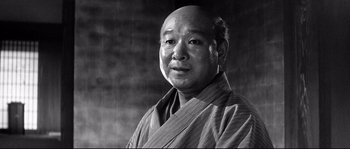 Movie still from “Harakiri” (1962), directed by Masaki Kobayashi – An older man wearing a robe in a black and white photo; Close Up shot, Low angle