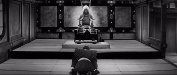 Movie still from “Harakiri” (1962), directed by Masaki Kobayashi – A man sitting on a chair in front of another man; Wide shot, High angle