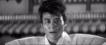 Movie still from “Harakiri” (1962), directed by Masaki Kobayashi – A black and white photo of a man with a strange look on his face; Close Up shot, Low angle