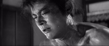 Movie still from “Harakiri” (1962), directed by Masaki Kobayashi – A man with a wet face and head covered in water; Close Up shot, High angle