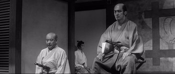 Movie still from “Harakiri” (1962), directed by Masaki Kobayashi – Three men in traditional japanese garb sitting in a room; Medium shot, Low angle