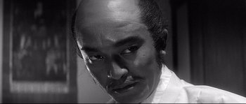 Movie still from “Harakiri” (1962), directed by Masaki Kobayashi – A black and white photo of a man with a mustache; Close Up shot, Low angle