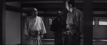 Movie still from “Harakiri” (1962), directed by Masaki Kobayashi – A group of men standing next to each other in a room; Medium shot, Low angle