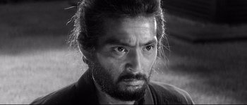 Movie still from “Harakiri” (1962), directed by Masaki Kobayashi – Black and white photograph of a man with a beard; Close Up shot, Over the shoulder angle