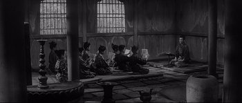 Movie still from “Harakiri” (1962), directed by Masaki Kobayashi – A black and white photo of a group of people sitting on the ground; Wide shot, High angle