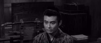 Movie still from “Harakiri” (1962), directed by Masaki Kobayashi – A man in a kimono is sitting in front of a chair; Close Up shot, High angle