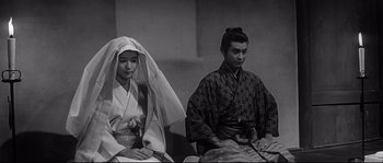 Movie still from “Harakiri” (1962), directed by Masaki Kobayashi – A man and a woman sitting next to each other; Medium shot, Low angle