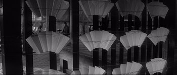 Movie still from “Harakiri” (1962), directed by Masaki Kobayashi – A man sitting at a table in front of an open window; Wide shot, Low angle