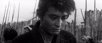 Movie still from “Harakiri” (1962), directed by Masaki Kobayashi – Black and white photograph of a young man in a traditional japanese garb; Close Up shot, Low angle