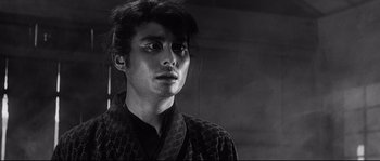 Movie still from “Harakiri” (1962), directed by Masaki Kobayashi – A man in a black robe looking to his left; Close Up shot, Low angle