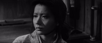 Movie still from “Harakiri” (1962), directed by Masaki Kobayashi – A black - and - white photo of a woman looking sad; Close Up shot, Low angle