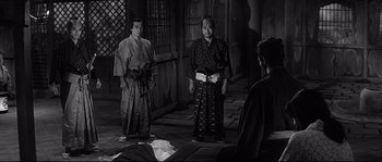 Movie still from “Harakiri” (1962), directed by Masaki Kobayashi – A group of men standing next to each other in a room; Wide shot, High angle