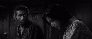 Movie still from “Harakiri” (1962), directed by Masaki Kobayashi – Two people standing next to each other in a dark room; Close Up shot, Low angle