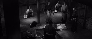 Movie still from “Harakiri” (1962), directed by Masaki Kobayashi – A group of people sitting around in a room; Wide shot, High angle
