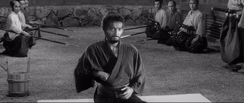 Movie still from “Harakiri” (1962), directed by Masaki Kobayashi – A black and white photo of a man in a kimono; Medium shot, Over the shoulder angle