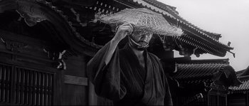 Movie still from “Harakiri” (1962), directed by Masaki Kobayashi – A man in a robe holding a straw hat; Close Up shot, Low angle