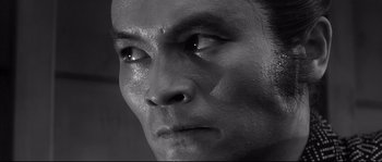 Movie still from “Harakiri” (1962), directed by Masaki Kobayashi – A man's face in black - and - white; Close Up shot, Low angle